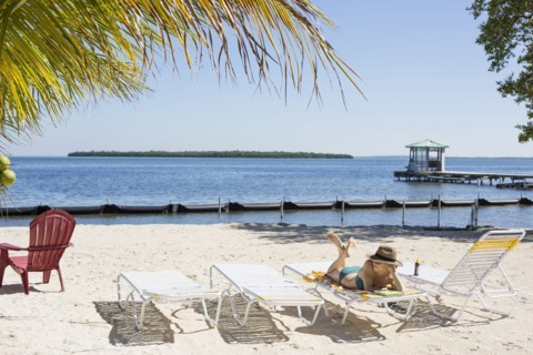 Caucasian woman relaxing on tropical beach