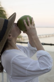 Caucasian woman drinking juice from coconut