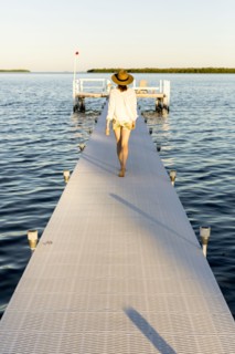 Caucasian woman walking on pier over water