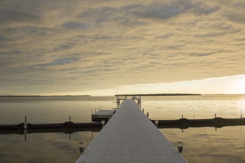 Clouds in sky over pier and ocean