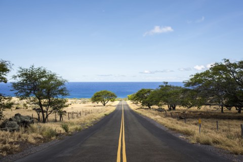 Empty road leading to ocean
