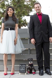 Couple with dog near wedding announcement