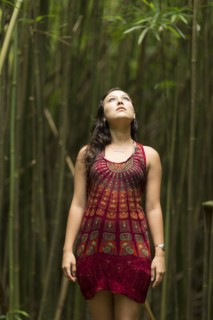 Caucasian woman standing in bamboo forest and looking up