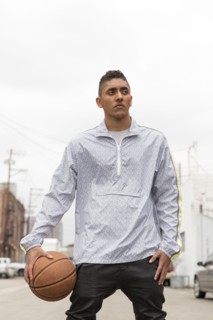 Portrait of curious Mixed Race man holding basketball