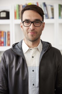 Portrait of smiling Caucasian man wearing jacket and eyeglasses