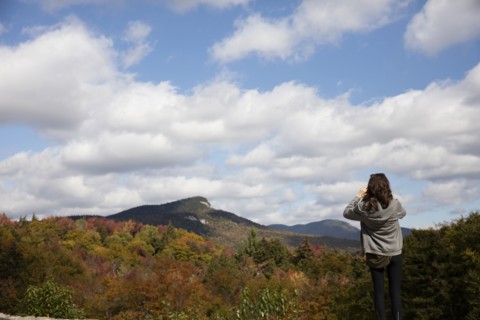 Caucasian woman admiring mountain range in autumn