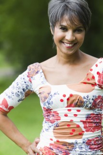 Smiling mixed race woman with hands on hips