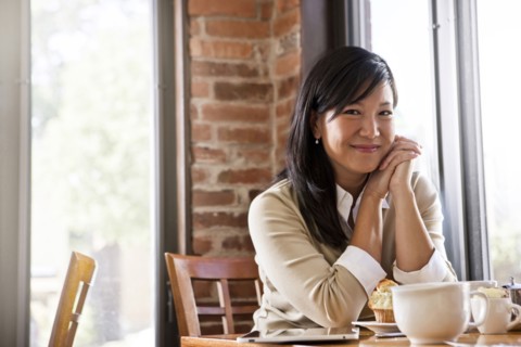 Chinese woman drinking coffee in cafe