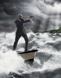 African American businessman using telescope on boat