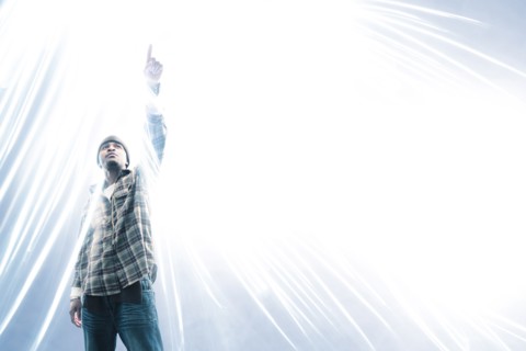 African American man pointing at light spark