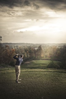 Caucasian man playing golf