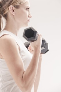 Caucasian woman exercising with dumbbells