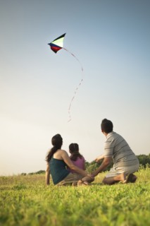 Family watching kite in sky
