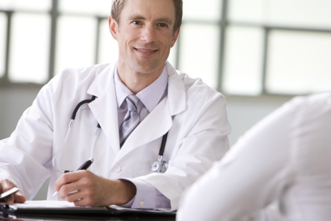 Caucasian doctor talking to patient
