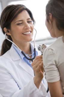 Smiling Doctor examining patient