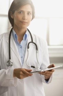 Hispanic doctor using digital tablet
