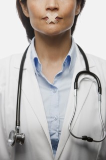 Hispanic doctor with bandages on mouth