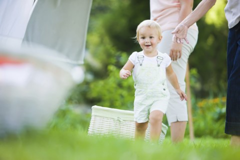 Caucasian baby running in grass