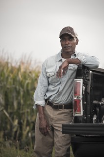 African American leaning on back of pick-up truck