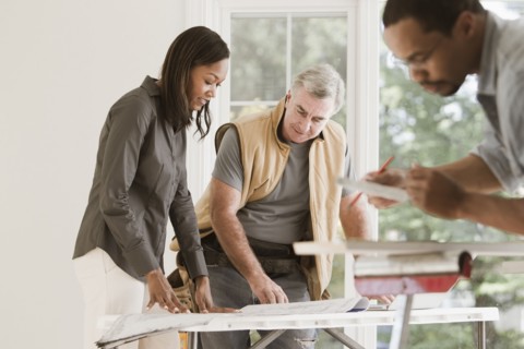 Man and woman looking at blueprints together