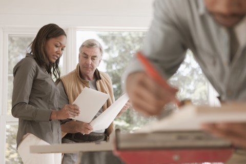 Man and woman looking at blueprints together