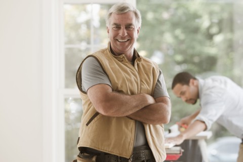 Caucasian carpenter standing with arms crossed