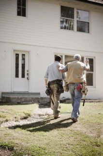 Carpenters walking toward house