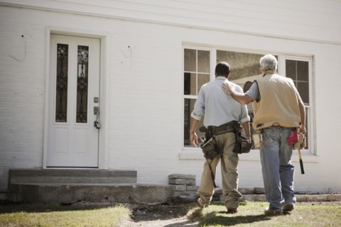 Carpenters walking toward house