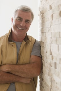 Caucasian man leaning against wall