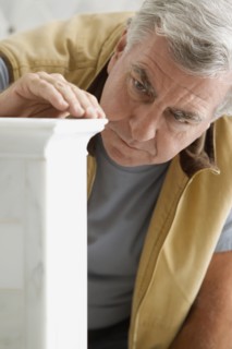 Caucasian carpenter looking at wood detail