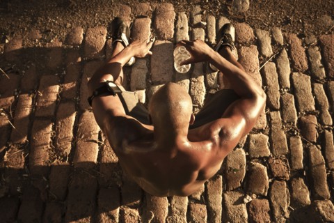 African American man drinking water after exercise