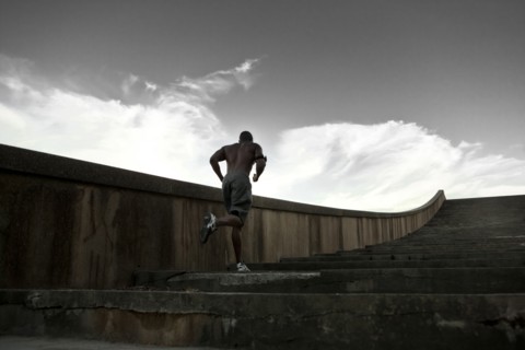 Black man running up stairs