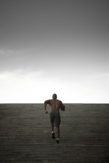 Black man running up stairs