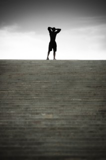 Black man stopping at top of stairs