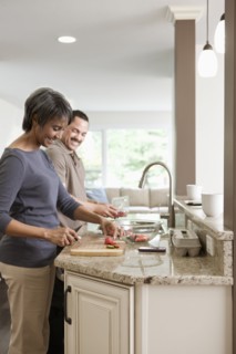 Couple preparing meal together in kitchen