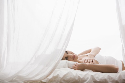 Caucasian woman laying in bed
