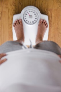 Caucasian woman standing on scale