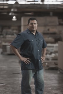 Hispanic worker standing in warehouse