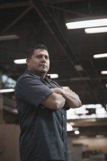 Hispanic worker standing in warehouse
