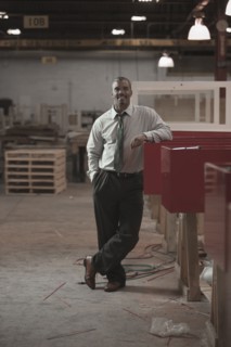Black businessman standing in warehouse
