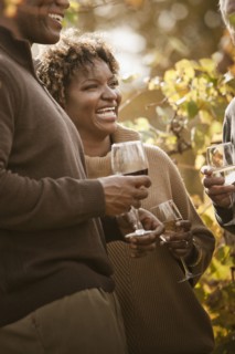 Friends drinking wine in vineyard