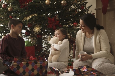 Family opening gifts Christmas morning