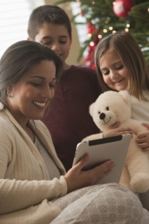 Family looking at digital tablet on Christmas morning