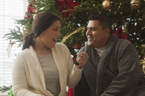 Wife opening keys to new car on Christmas morning