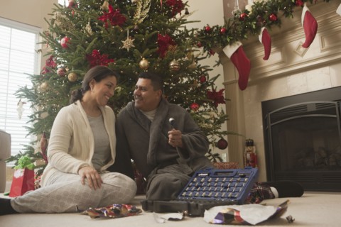 Couple opening gifts on Christmas morning