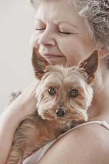 Caucasian woman holding dog