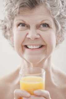 Caucasian woman drinking orange juice
