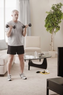 Caucasian man exercising in living room