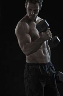 Caucasian man exercising with hand weights