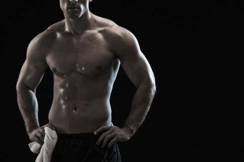 Bare chested Caucasian man with hands on hips